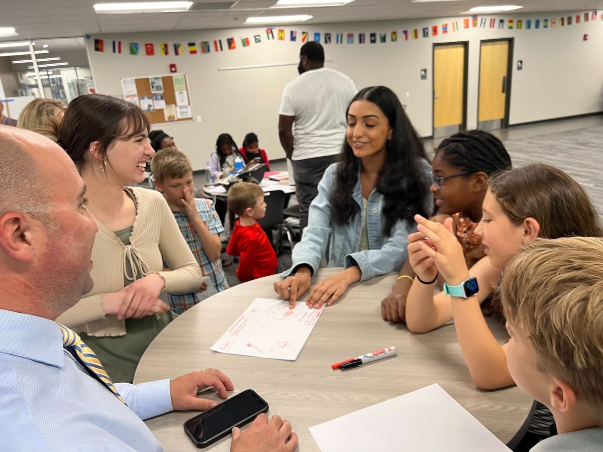 Students and adults in conversation